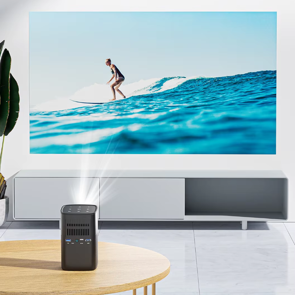 How to Build a Projector Quality Control Checklist for Bulk Orders 2 Compact portable projector displaying a surfing scene in a bright modern living room